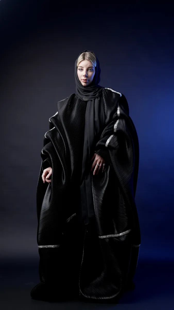 Studio fashion portrait in a sculptural black outfit