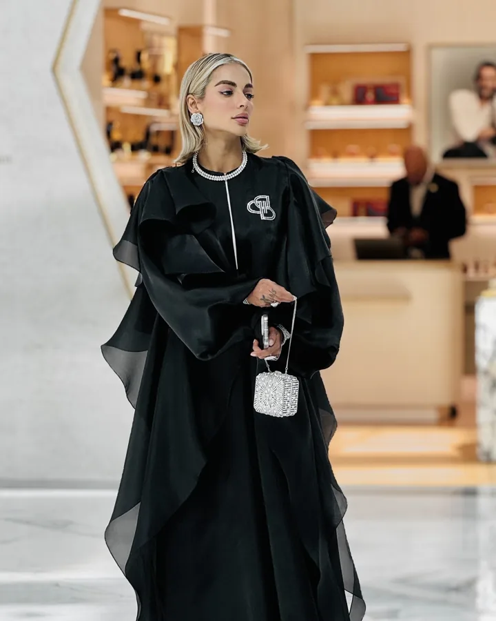 Fashion portrait with silver accessories in a warm interior