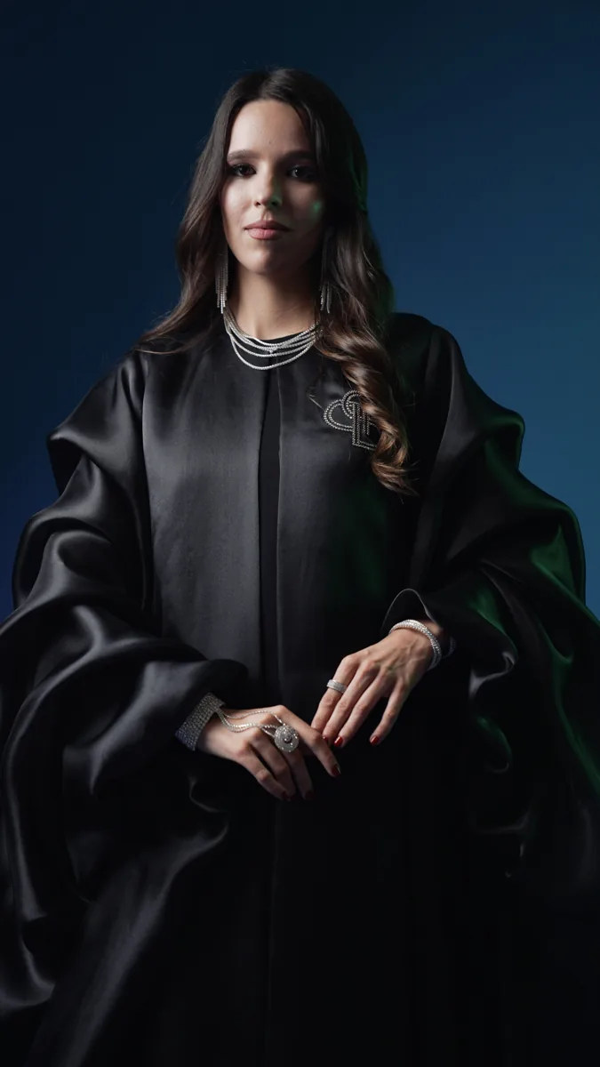 Seated fashion portrait in black with silver jewelry